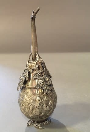 Silver perf,e sprinkler in the shape of a pear