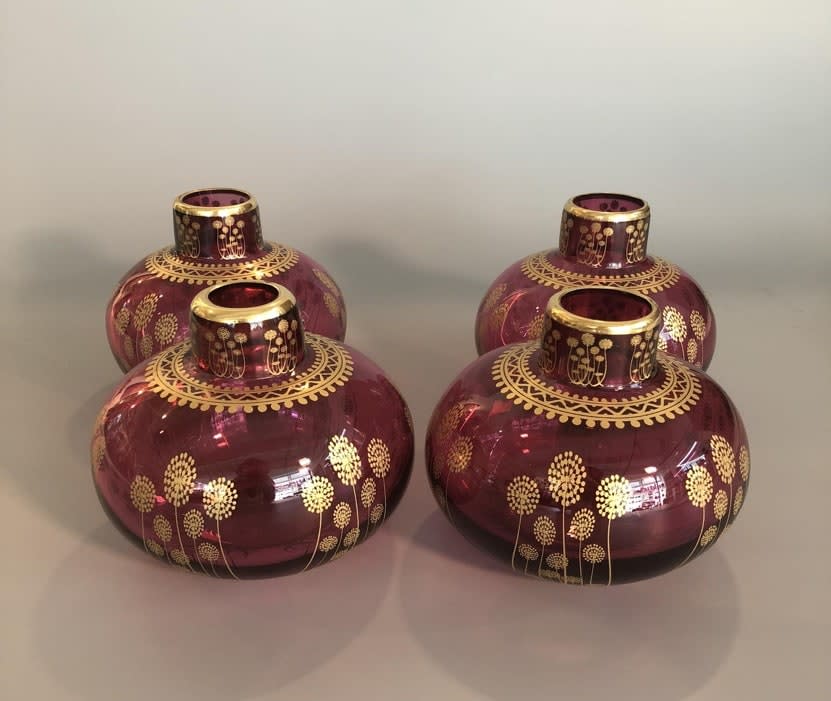 Four purple glass vases with gold decoration
