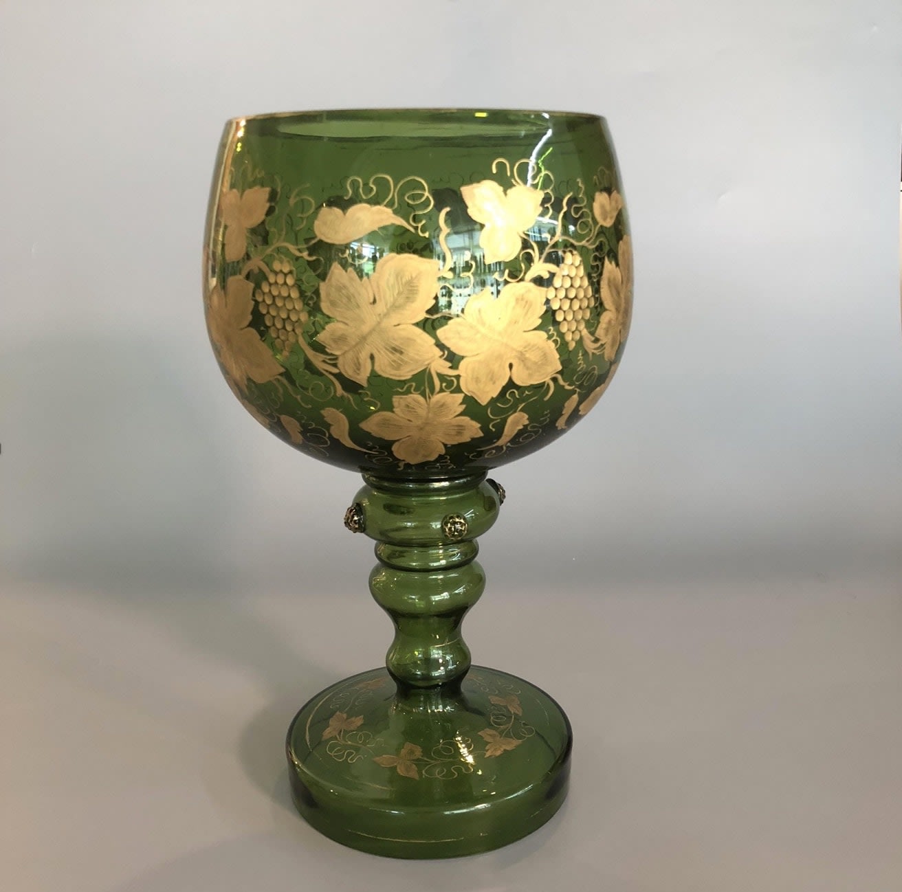 Green wine glass with gold decoration