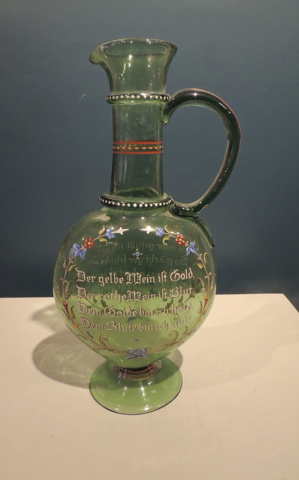 Green glass jug with a celebratory informal inscription