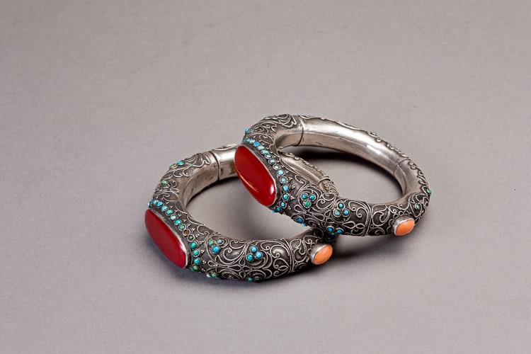 Two silver filigree child bracelets decorated by oval carnelians, coral and lapis lazuli