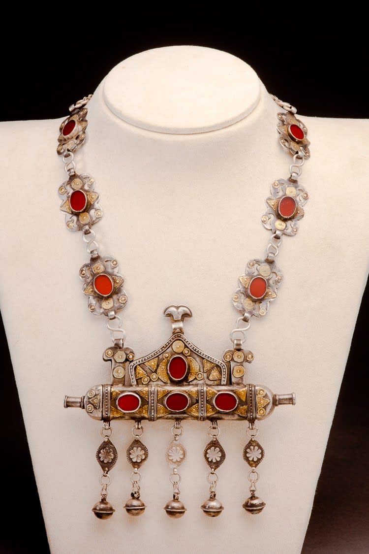 Turkoman silver and carnelian amulet case with bells, on short chain