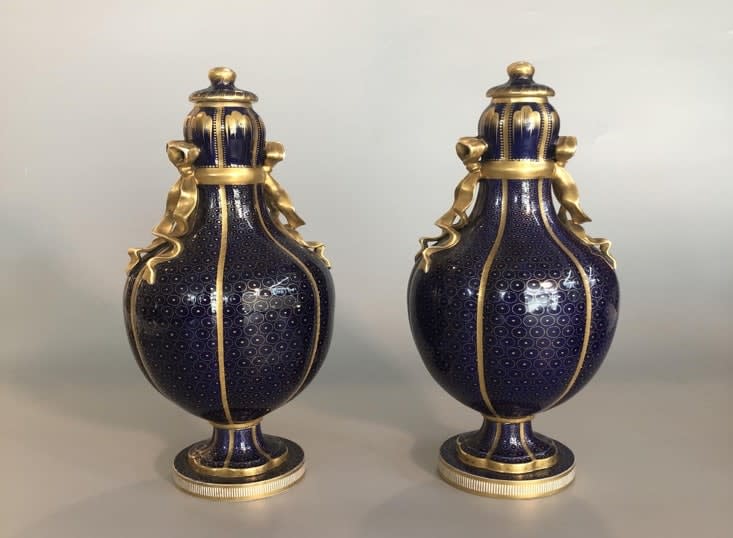 Pair of blue glass lidded vases and gold decoration