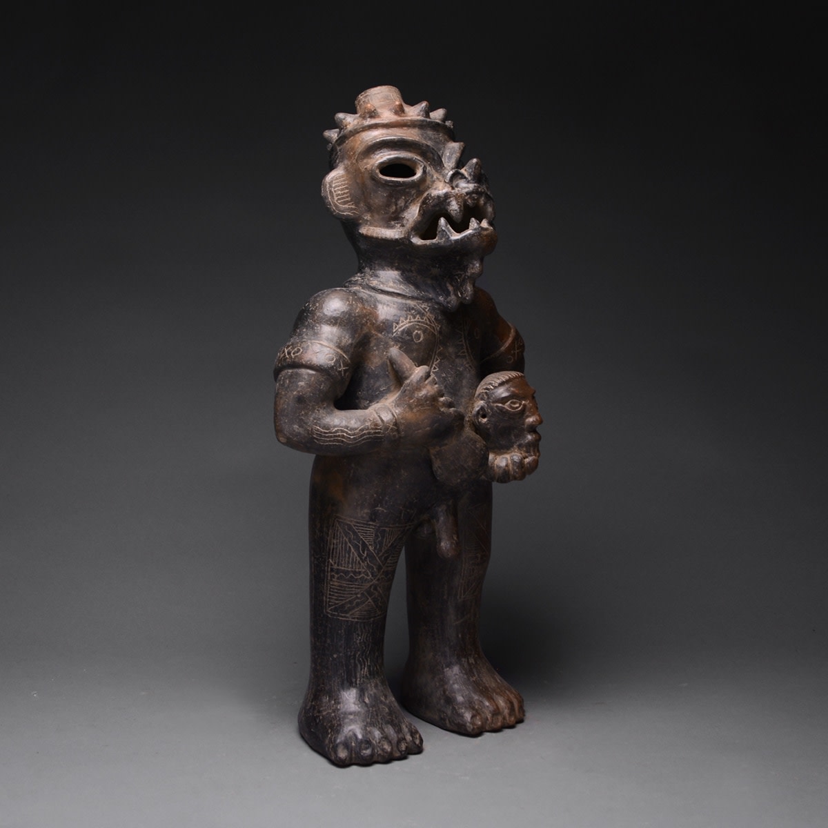 Guanacaste-Nicoya Blackware Sculpture of Saurian Deity Holding Celt and Head, 500 CE - 1000 CE