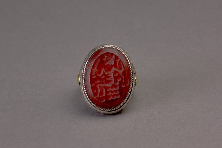 Oval silver Islamic ring with carnelian intaglio of a seated figure in profile to the right