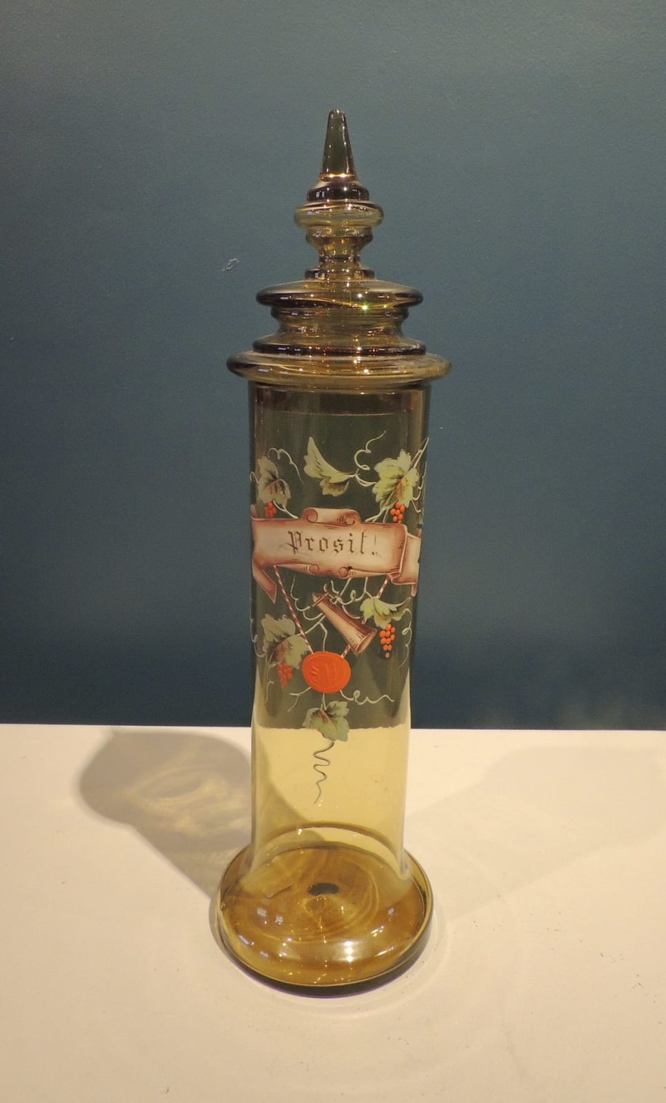 Lidded tubular form vessel in smoky green glass