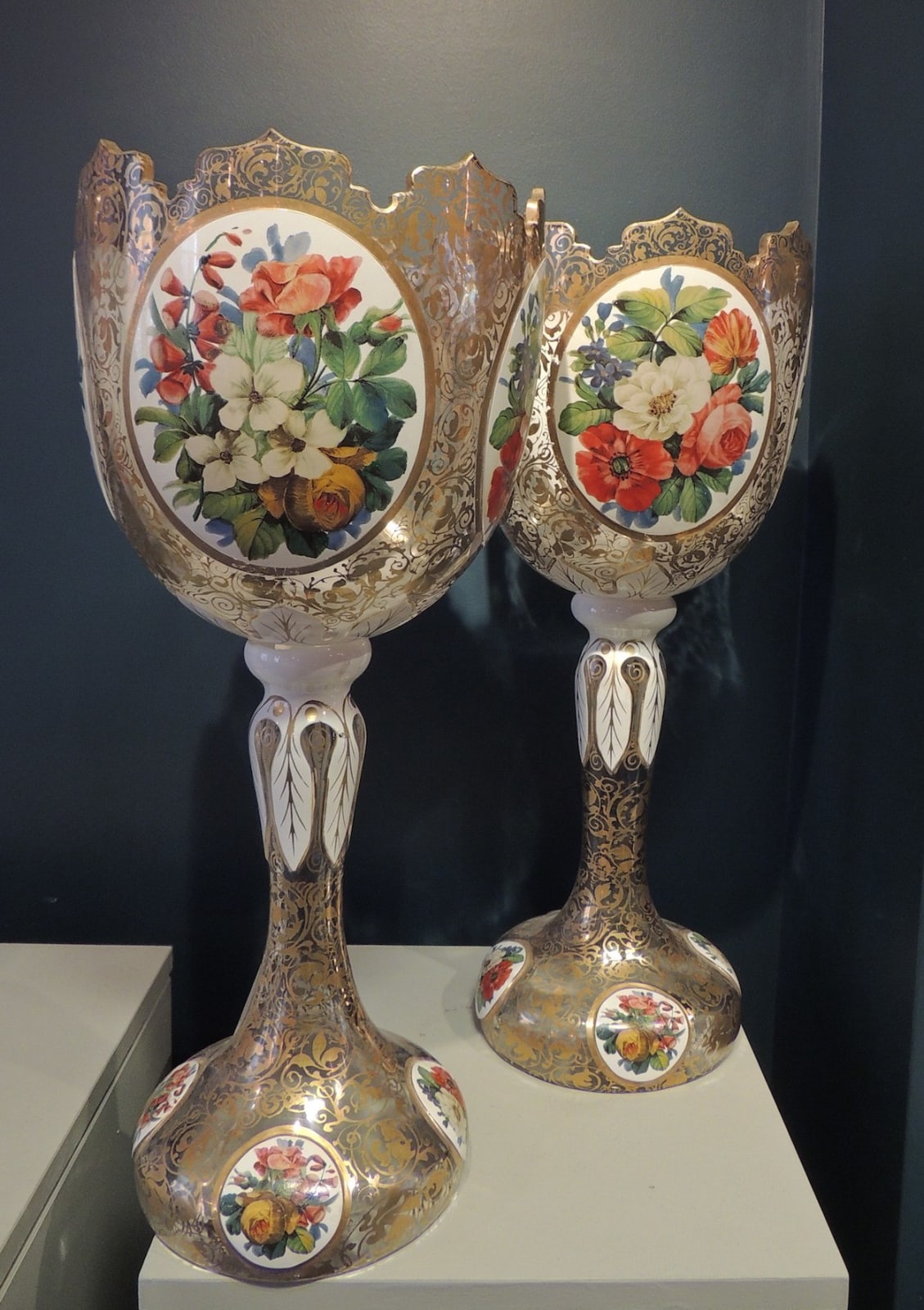Pair of clear glass stemmed vases with floral decoration