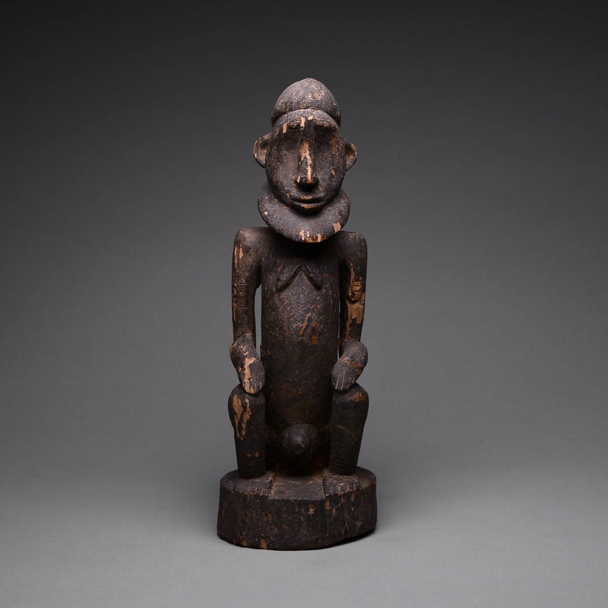 Dogon Wooden Sculpture of a Seated Man, 20th Century CE