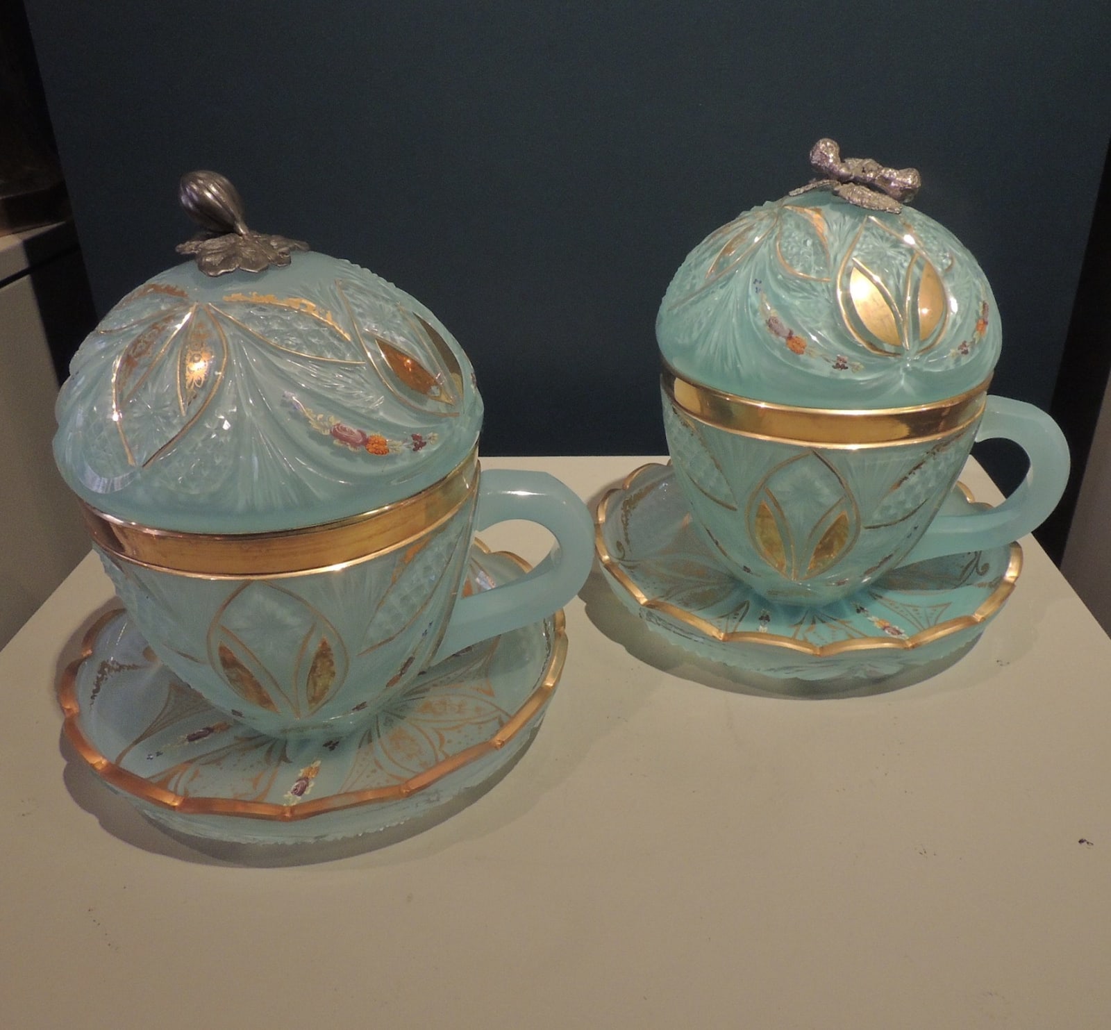 Pair of blue glass bombonieres with floral silver knobs