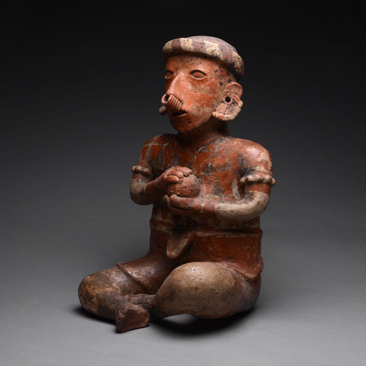 Ixtlán del Rio Style Nayarit Terracotta Sculpture of a Seated Man Holding a Ball, 100 BC to 250 AD