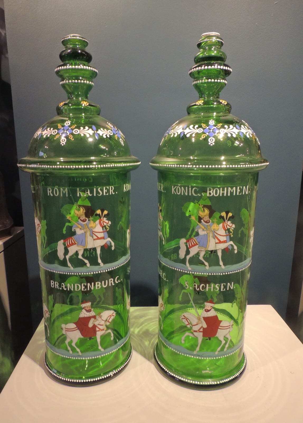 Pair of lidded tubular shape sweetmeat vases of green glass