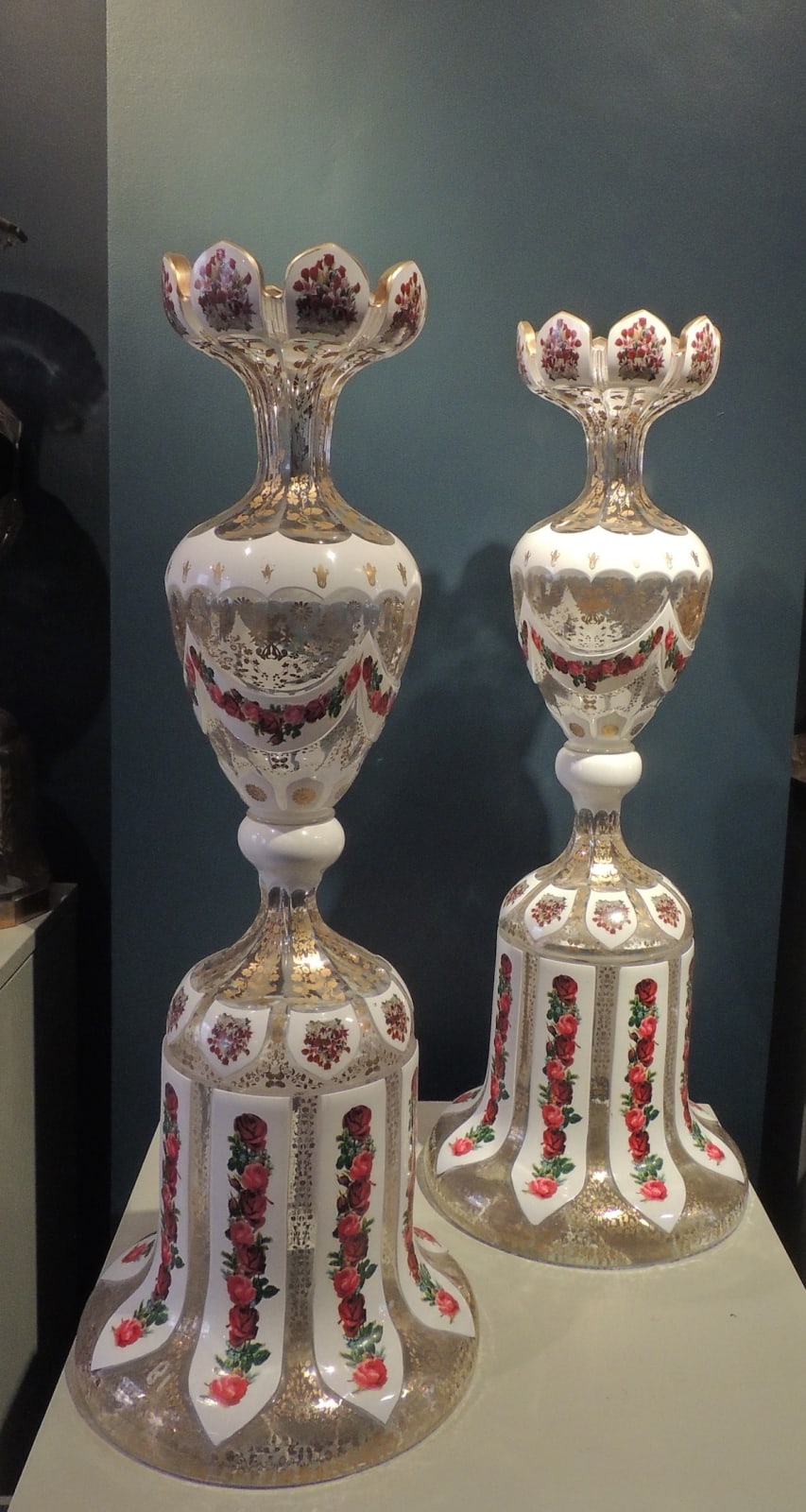 Pair of decorative crenelated vases on pedestals