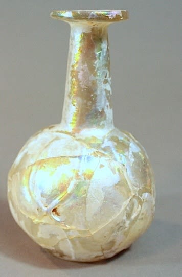 Islamic mould-blown clear glass bottle of globular form, with long tapering neck, the decoration wit, 800 CE - 900 CE