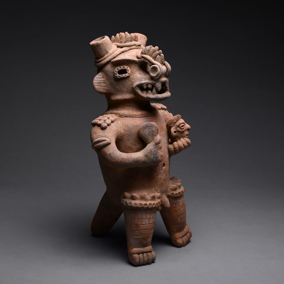 Sculpture of a Standing Saurian Deity Holding a Club and a Head, 100 BCE - 500 CE
