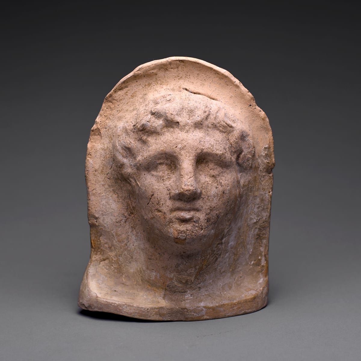 An Etruscan Terracotta Votive Head of a Youthful Man, 4th Century BC to 3rd Century BC