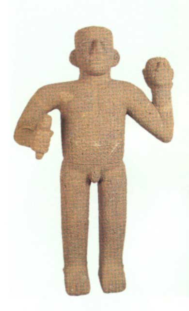 Basalt Sculpture of a Standing Man Holding an Axe and a Trophey Head, 1000 CE - 1500 CE