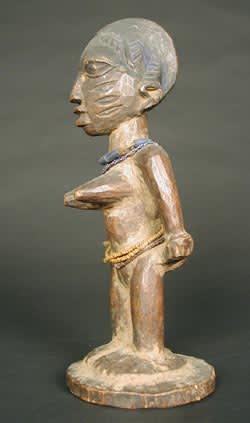 Yoruba Wooden Ibeji Doll with Cowrie Shell Cloak, 20th Century CE