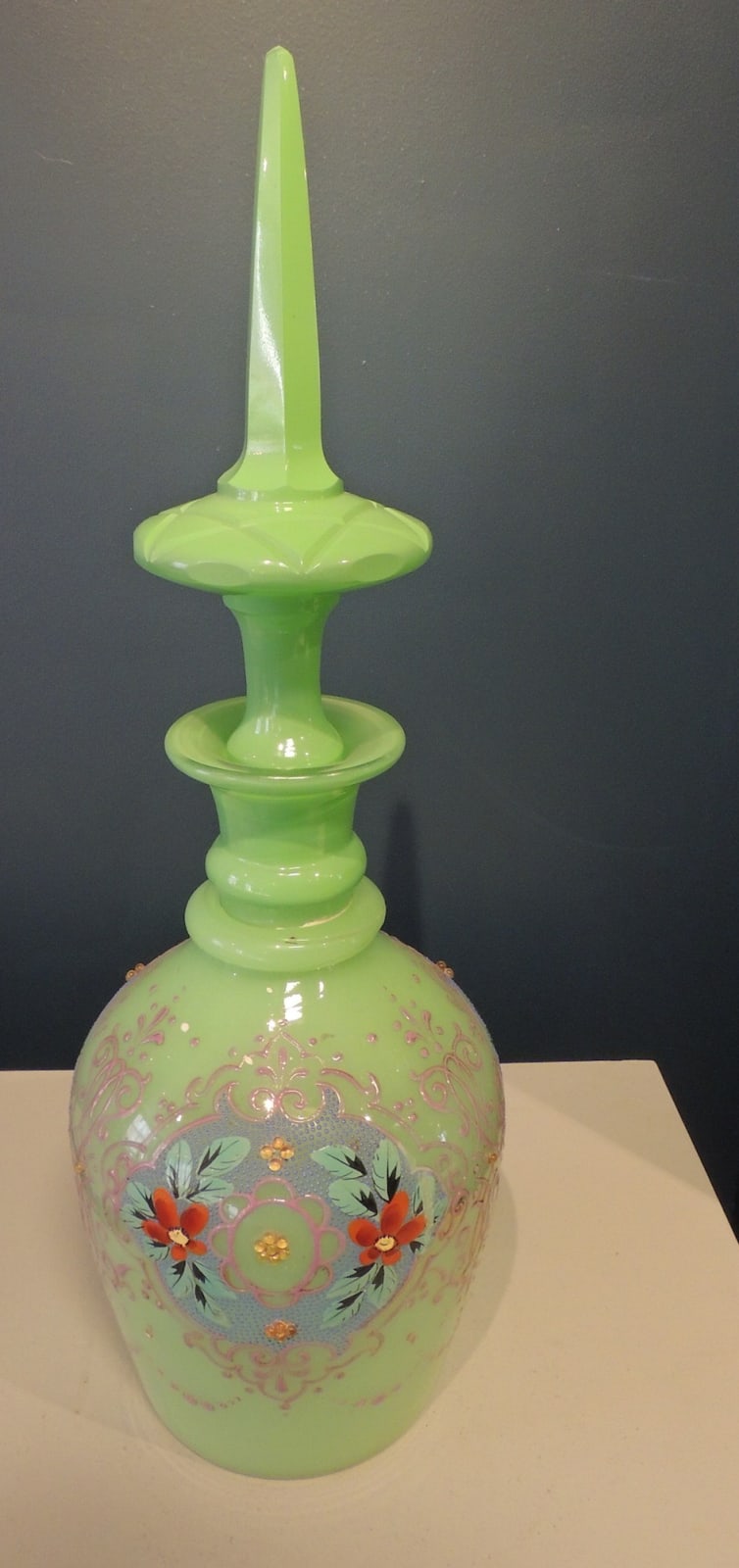 Lidded glass bottle with floral decorations