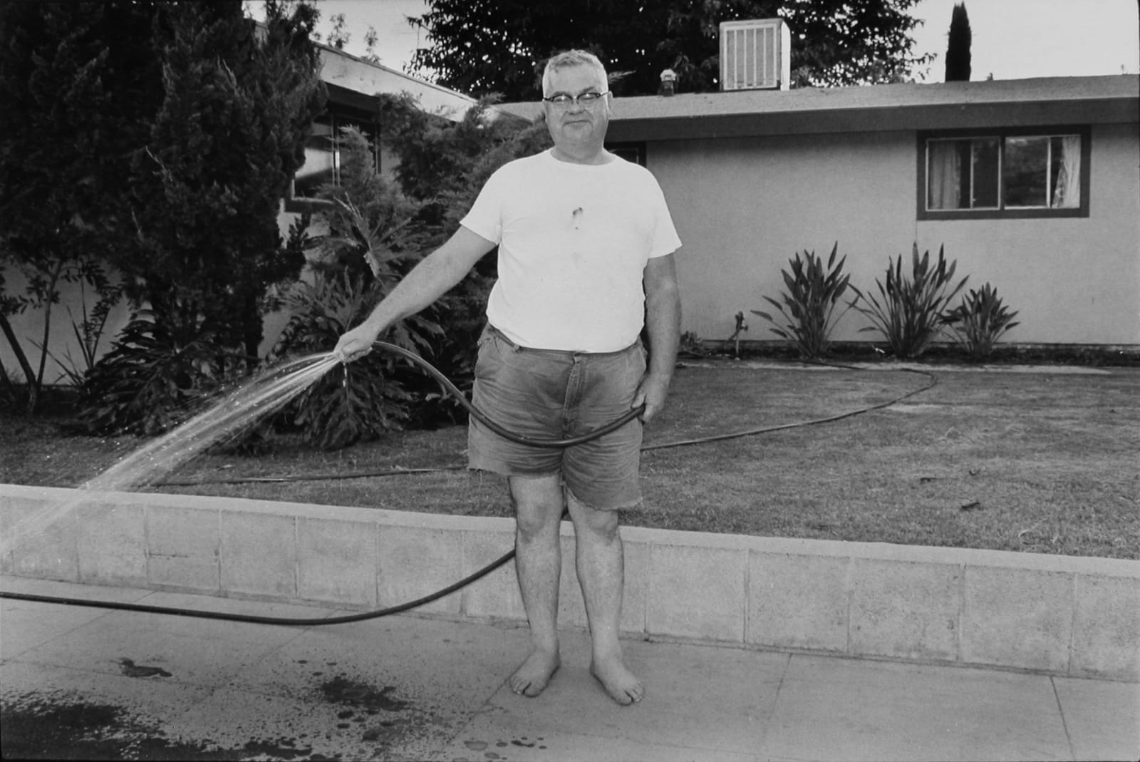 John Divola, Untitled (man watering lawn), 1971–73