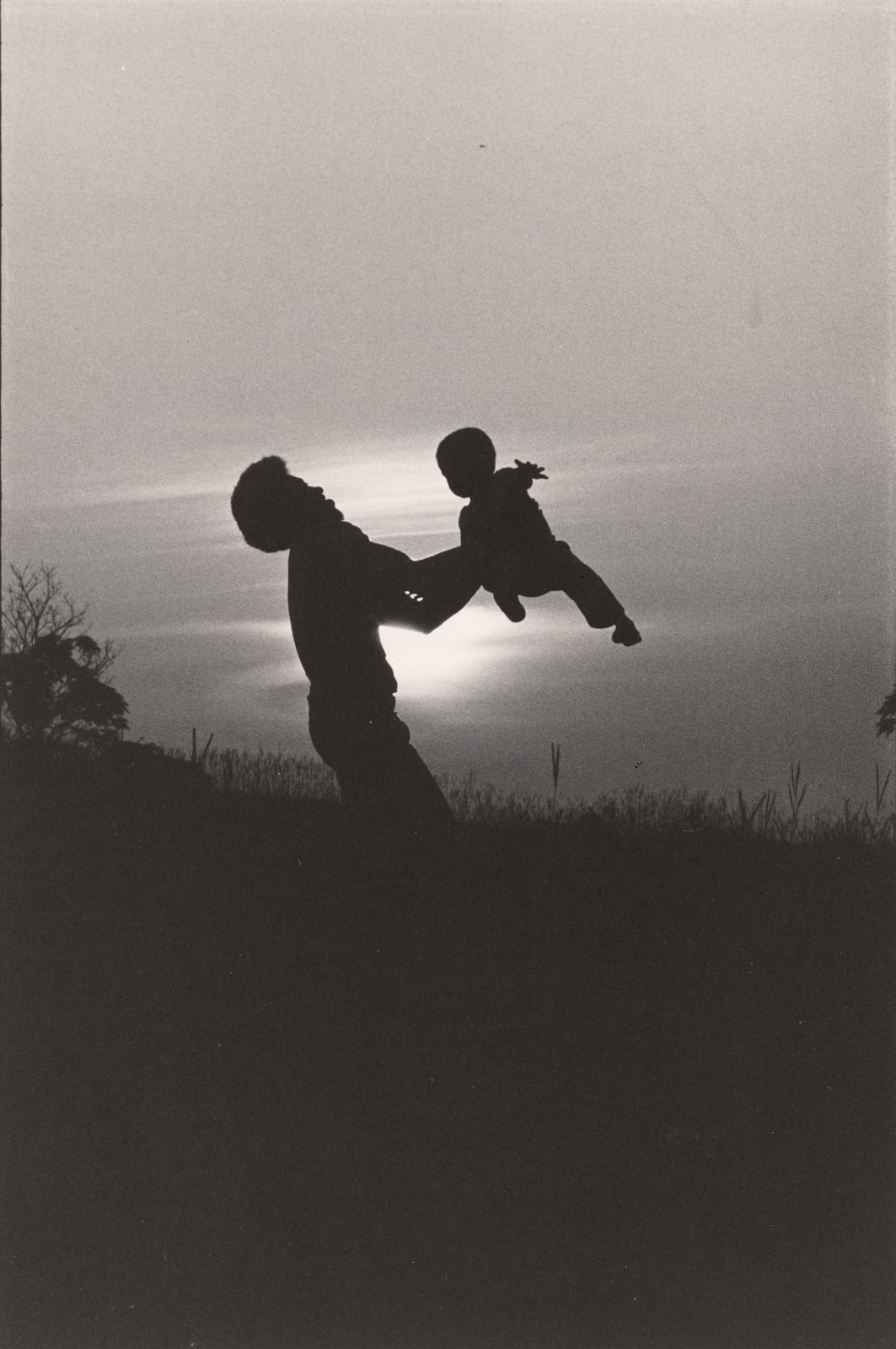 Chester Higgins, Father Swings Son in Sunset, Tuskegee, Alabama, 1973