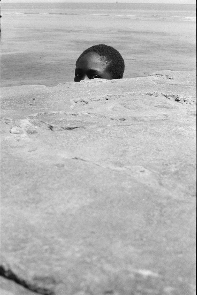 Jimmie Mannas, Peeping Sea Wall Beach Boy, Sea Wall, Georgetown, Guyana, 1972