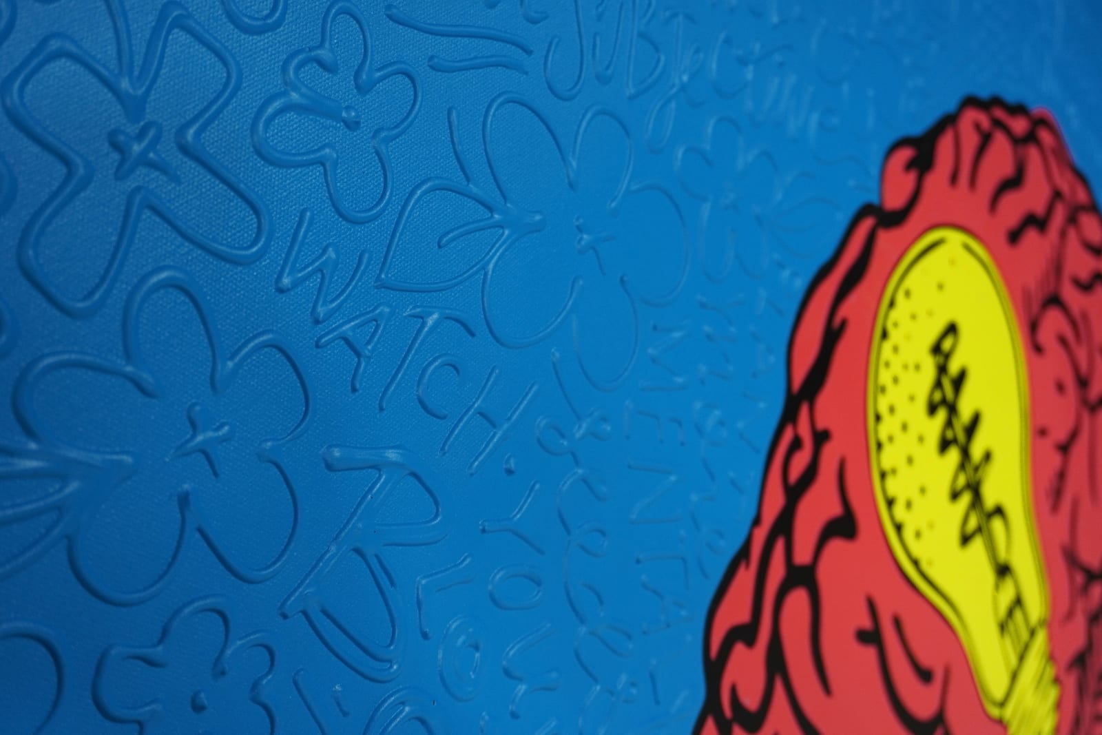 Detail photo of “La Mente”, painting by Cayla Birk artist from South Florida. Available at Carousel Fine Art Chicago. The artist’s technique blends traditional acrylic paints with unique materials, creating a distinct mixed media style. Birk's work is marked by intricate designs and recognizable gestures, combining contemporary culture, history, music, and literature. Her art challenges conventional thinking, offering new and unexpected experiences. Colors of this work : Red, Blue, Yellow, Beige, Black