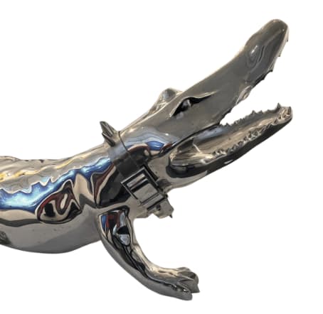 Detail photo of “Crocodile”, sculpture by Richard Orlinski artist from Paris, France. Available at Carousel Fine Art Miami. The artist’s technique involves aluminum and is renowned for his depictions of animals from mass culture in Pop and Street Art. A signature element in his work, these animals embody wild power, speed, and ferocity, reflecting the 'Born Wild' concept. Colors of this work of: Silver