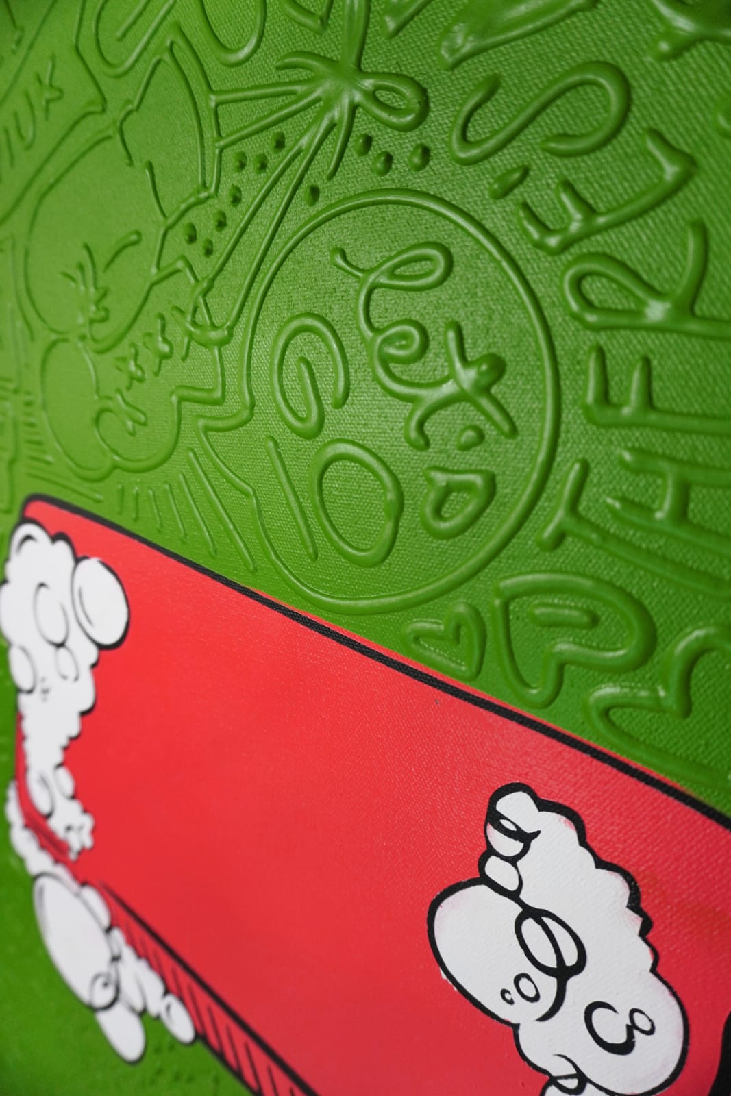 Detail photo of “El Fight Club”, painting by Cayla Birk artist from South Florida. Available at Carousel Fine Art Chicago. The artist’s technique blends traditional acrylic paints with unique materials, creating a distinct mixed media style. Birk's work is marked by intricate designs and recognizable gestures, combining contemporary culture, history, music, and literature. Her art challenges conventional thinking, offering new and unexpected experiences. Colors of this work : Green, Red, Beige, White, Black