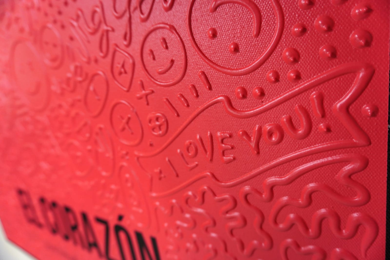 Detail photo of “El Corazón”, painting by Cayla Birk artist from South Florida. Available at Carousel Fine Art Chicago. The artist’s technique blends traditional acrylic paints with unique materials, creating a distinct mixed media style. Birk's work is marked by intricate designs and recognizable gestures, combining contemporary culture, history, music, and literature. Her art challenges conventional thinking, offering new and unexpected experiences. Colors of this work : Red, Blue, Yellow, Beige, Black