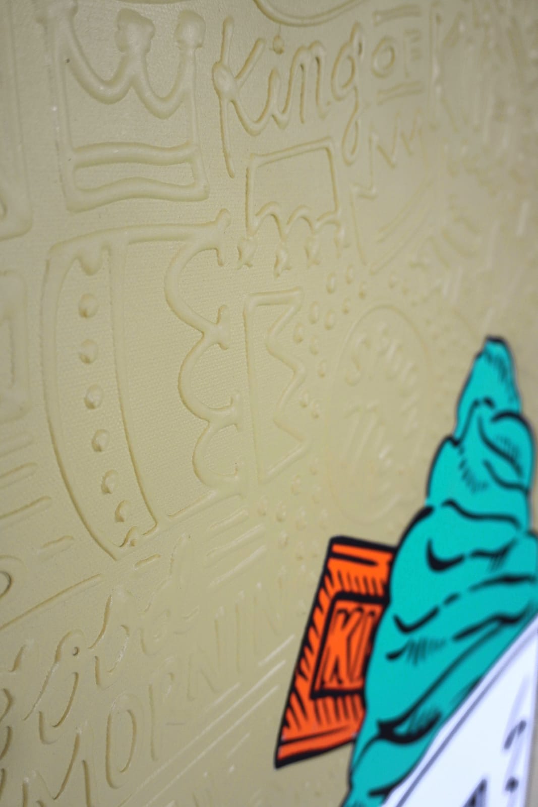 Detail photo of “El Treat”, painting by Cayla Birk artist from South Florida. Available at Carousel Fine Art Chicago. The artist’s technique blends traditional acrylic paints with unique materials, creating a distinct mixed media style. Birk's work is marked by intricate designs and recognizable gestures, combining contemporary culture, history, music, and literature. Her art challenges conventional thinking, offering new and unexpected experiences. Colors of this work : Teal, Orange, Beige, White, BlackDetail photo of “El Treat”, painting by Cayla Birk artist from Florida. Available at Carousel Fine Art Chicago. The artist’s technique blends traditional acrylic paints with unique materials, creating a distinct mixed media style. Birk's work is marked by intricate designs and recognizable gestures, combining contemporary culture, history, music, and literature. Her art challenges conventional thinking, offering new and unexpected experiences. Colors of this work : Teal, Orange, Beige, White, Black