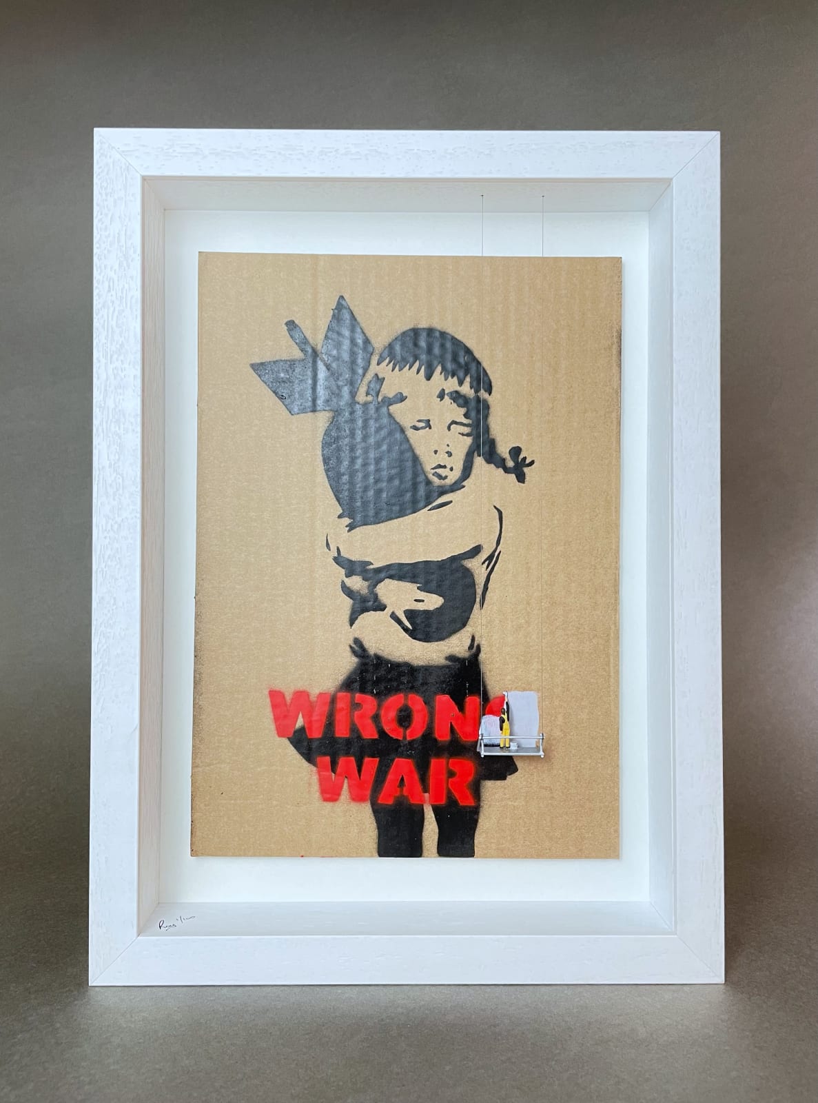 “Scrubbed Out Bomb Hugger”, mixed media artwork by Roy’s People artist from London. Available at Carousel Fine New Buffalo.