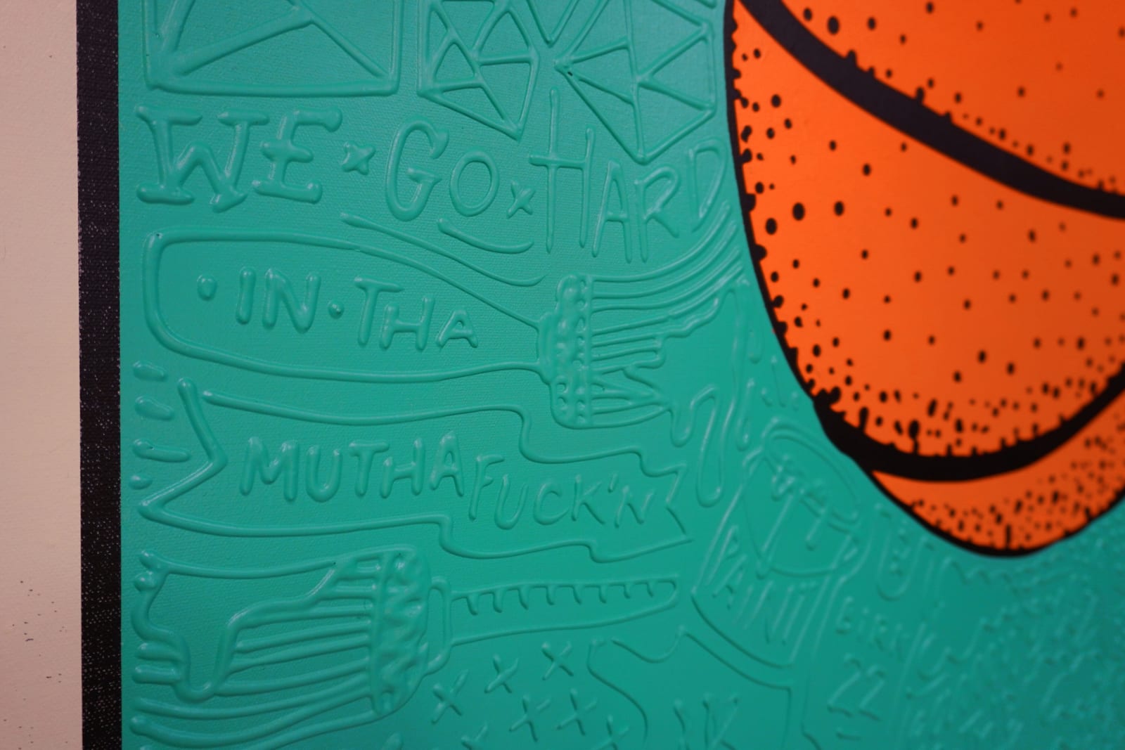 Detail photo of “El Balón”, painting by Cayla Birk artist from South Florida. Available at Carousel Fine Art Chicago. The artist’s technique blends traditional acrylic paints with unique materials, creating a distinct mixed media style. Birk's work is marked by intricate designs and recognizable gestures, combining contemporary culture, history, music, and literature. Her art challenges conventional thinking, offering new and unexpected experiences. Colors of this work : Teal, Orange, Beige, Black