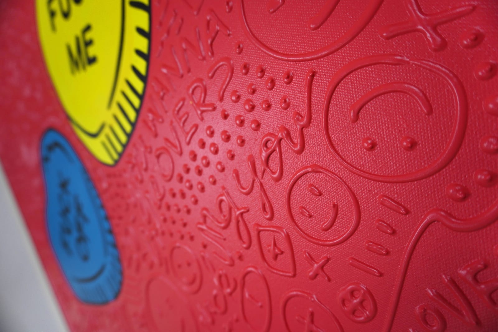 Detail photo of “El Corazón”, painting by Cayla Birk artist from South Florida. Available at Carousel Fine Art Chicago. The artist’s technique blends traditional acrylic paints with unique materials, creating a distinct mixed media style. Birk's work is marked by intricate designs and recognizable gestures, combining contemporary culture, history, music, and literature. Her art challenges conventional thinking, offering new and unexpected experiences. Colors of this work : Red, Blue, Yellow, Beige, Black