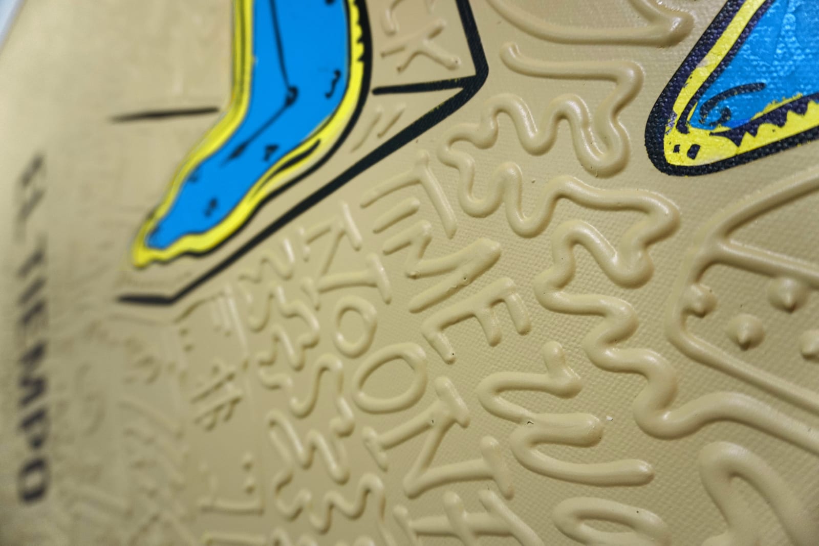 Detail photo of “El Tiempo”, painting by Cayla Birk artist from South Florida. Available at Carousel Fine Art Chicago. The artist’s technique blends traditional acrylic paints with unique materials, creating a distinct mixed media style. Birk's work is marked by intricate designs and recognizable gestures, combining contemporary culture, history, music, and literature. Her art challenges conventional thinking, offering new and unexpected experiences. Colors of this work : Blue, Yellow, Beige, Black