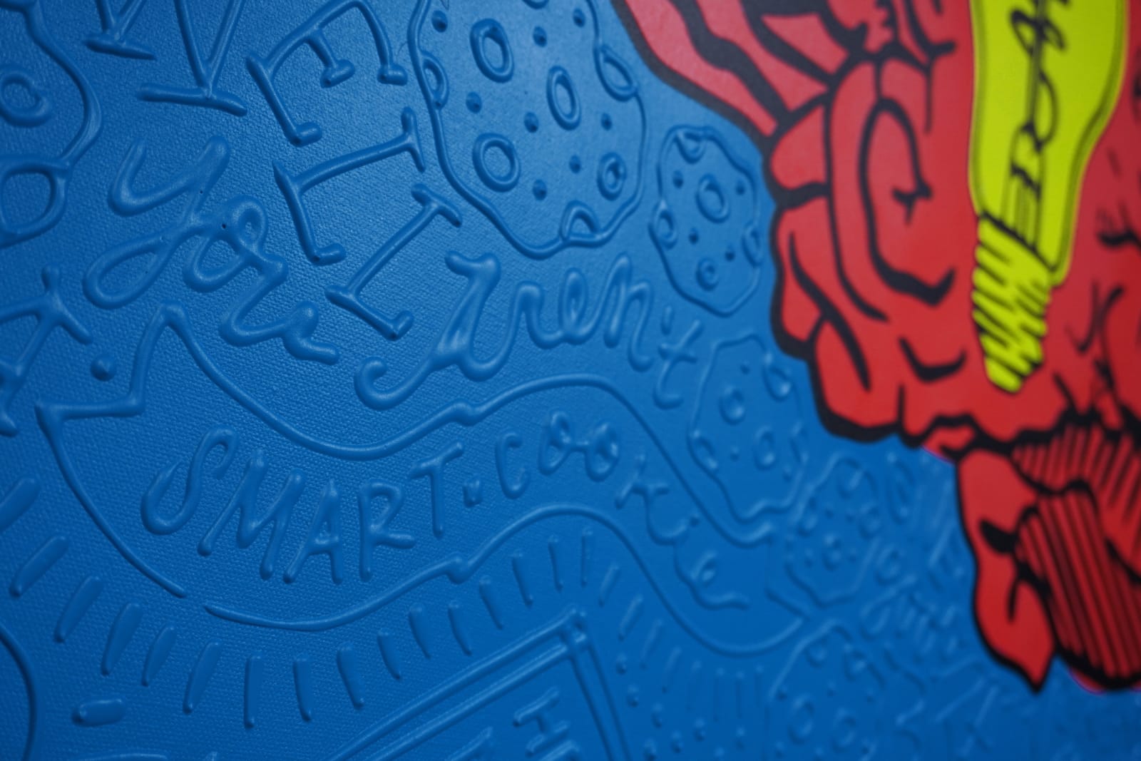 Detail photo of “La Mente”, painting by Cayla Birk artist from South Florida. Available at Carousel Fine Art Chicago. The artist’s technique blends traditional acrylic paints with unique materials, creating a distinct mixed media style. Birk's work is marked by intricate designs and recognizable gestures, combining contemporary culture, history, music, and literature. Her art challenges conventional thinking, offering new and unexpected experiences. Colors of this work : Red, Blue, Yellow, Beige, Black