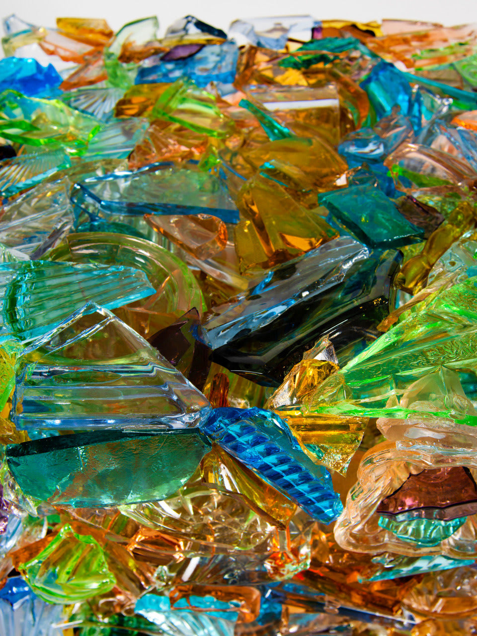 “I Have A Little Crush”, sculpture by Sandra Sashou. Sculpture is made from reassembled broken pieces of glass that are Art Deco Vanity Sets. The multicolor glass appears almost as sea glass with vibrant colors of green, lime green, turquoise, orange, cerulean and light rosy pink. Available at Carousel Fine Art Miami.