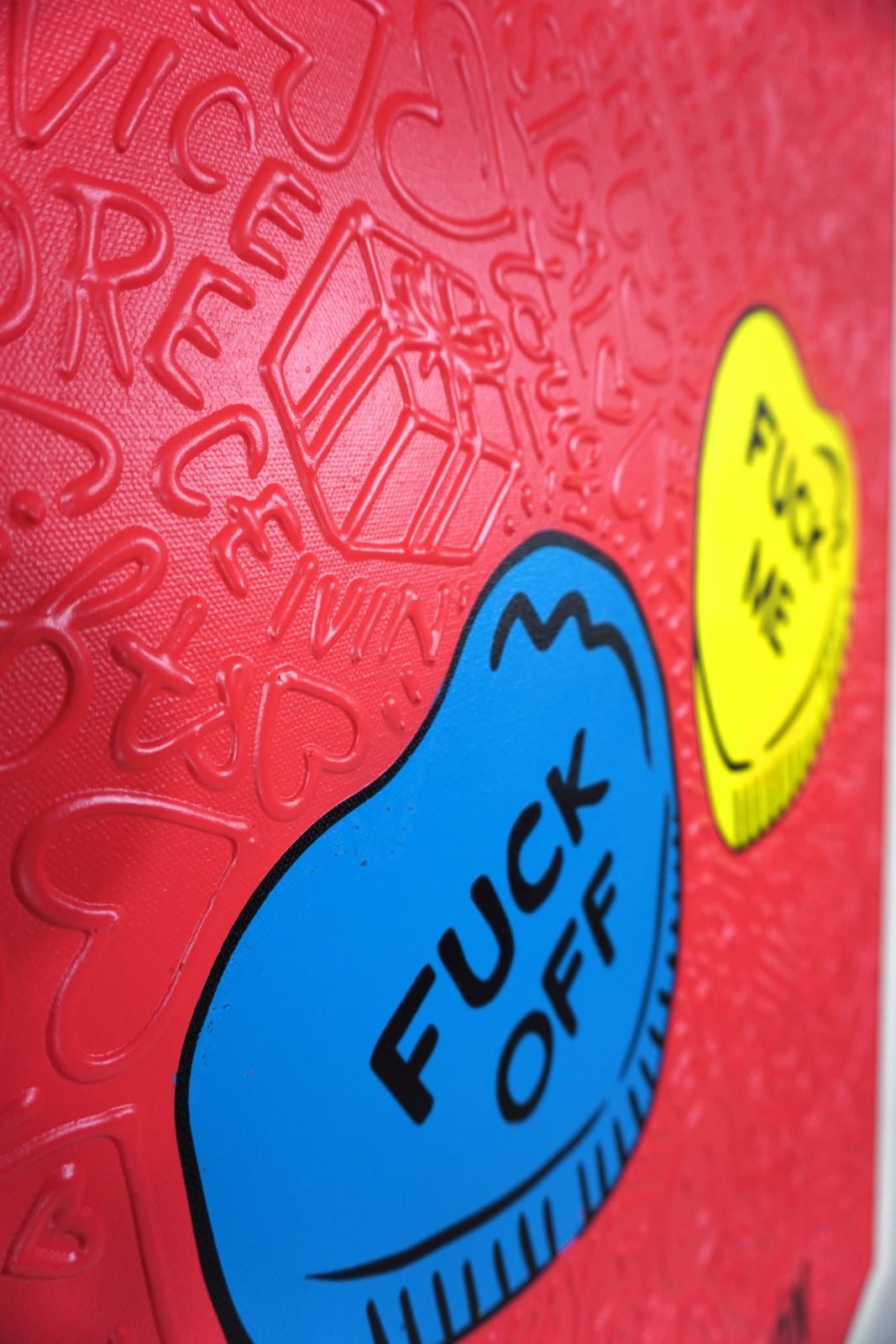 Detail photo of “El Corazón”, painting by Cayla Birk artist from South Florida. Available at Carousel Fine Art Chicago. The artist’s technique blends traditional acrylic paints with unique materials, creating a distinct mixed media style. Birk's work is marked by intricate designs and recognizable gestures, combining contemporary culture, history, music, and literature. Her art challenges conventional thinking, offering new and unexpected experiences. Colors of this work : Red, Blue, Yellow, Beige, Black