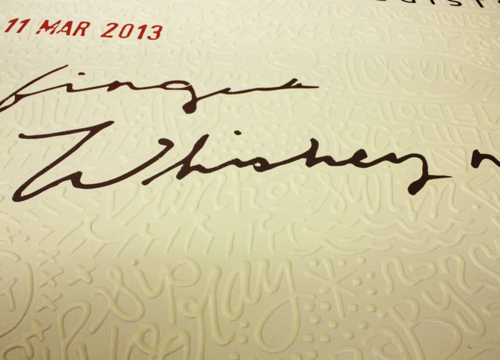 Detail photo of “Whiskey Neat”, painting by Cayla Birk artist from South Florida. Available at Carousel Fine Art Atlanta. The artist’s technique blends acrylic, spray paint and silicone on canvas, creating a distinct mixed media style. Birk's work is marked by intricate designs and recognizable gestures, combining contemporary culture, history, music, and literature. Her art challenges conventional thinking, offering new and unexpected experiences. Colors of this work : Beige, Red, Black