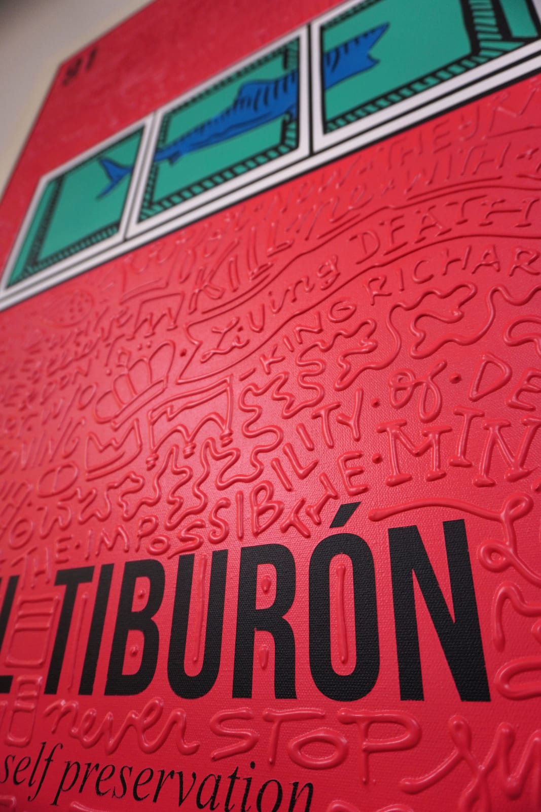 Detail photo of “El Tiburón”, painting by Cayla Birk artist from South Florida. Available at Carousel Fine Art Chicago. The artist’s technique blends traditional acrylic paints with unique materials, creating a distinct mixed media style. Birk's work is marked by intricate designs and recognizable gestures, combining contemporary culture, history, music, and literature. Her art challenges conventional thinking, offering new and unexpected experiences. Colors of this work : Red, Blue, Teal, Beige, White, Black from Florida. Available at Carousel Fine Art Chicago. The artist’s technique blends traditional acrylic paints with unique materials, creating a distinct mixed media style. Birk's work is marked by intricate designs and recognizable gestures, combining contemporary culture, history, music, and literature. Her art challenges conventional thinking, offering new and unexpected experiences. Colors of this work : Red, Blue, Teal, Beige, White, Black