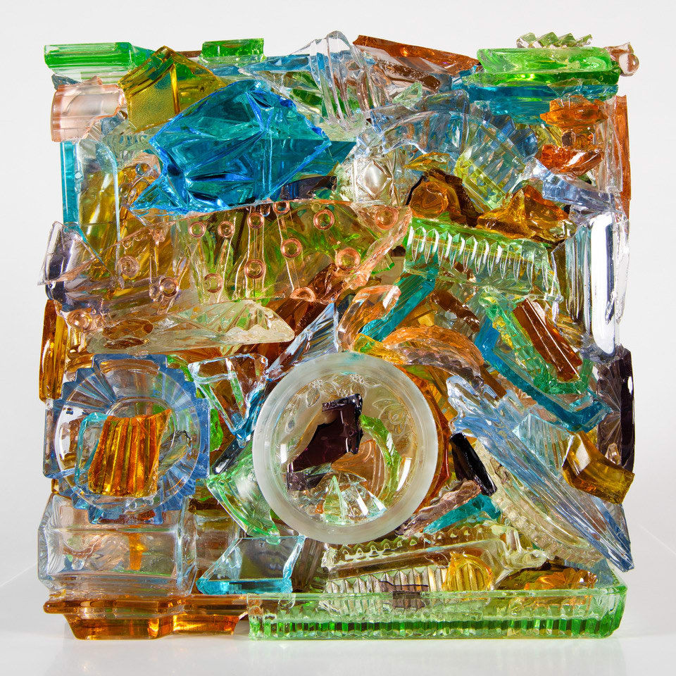 “I Have A Little Crush”, sculpture by Sandra Sashou. Sculpture is made from reassembled broken pieces of glass that are Art Deco Vanity Sets. The multicolor glass appears almost as sea glass with vibrant colors of green, lime green, turquoise, orange, cerulean and light rosy pink. Available at Carousel Fine Art Miami.