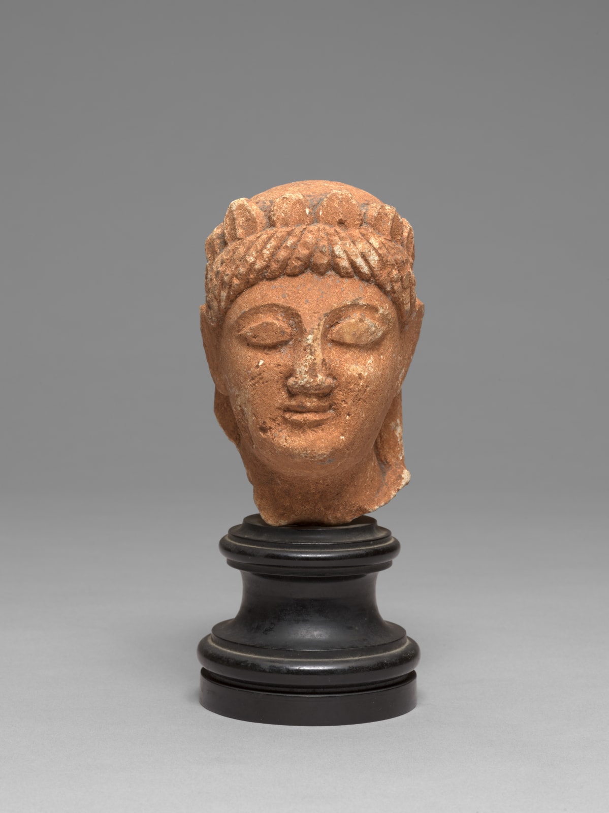 CYPRIOT HEAD OF A VOTARY, Archaic Period, circa late 6th-early 5th Century B.C.