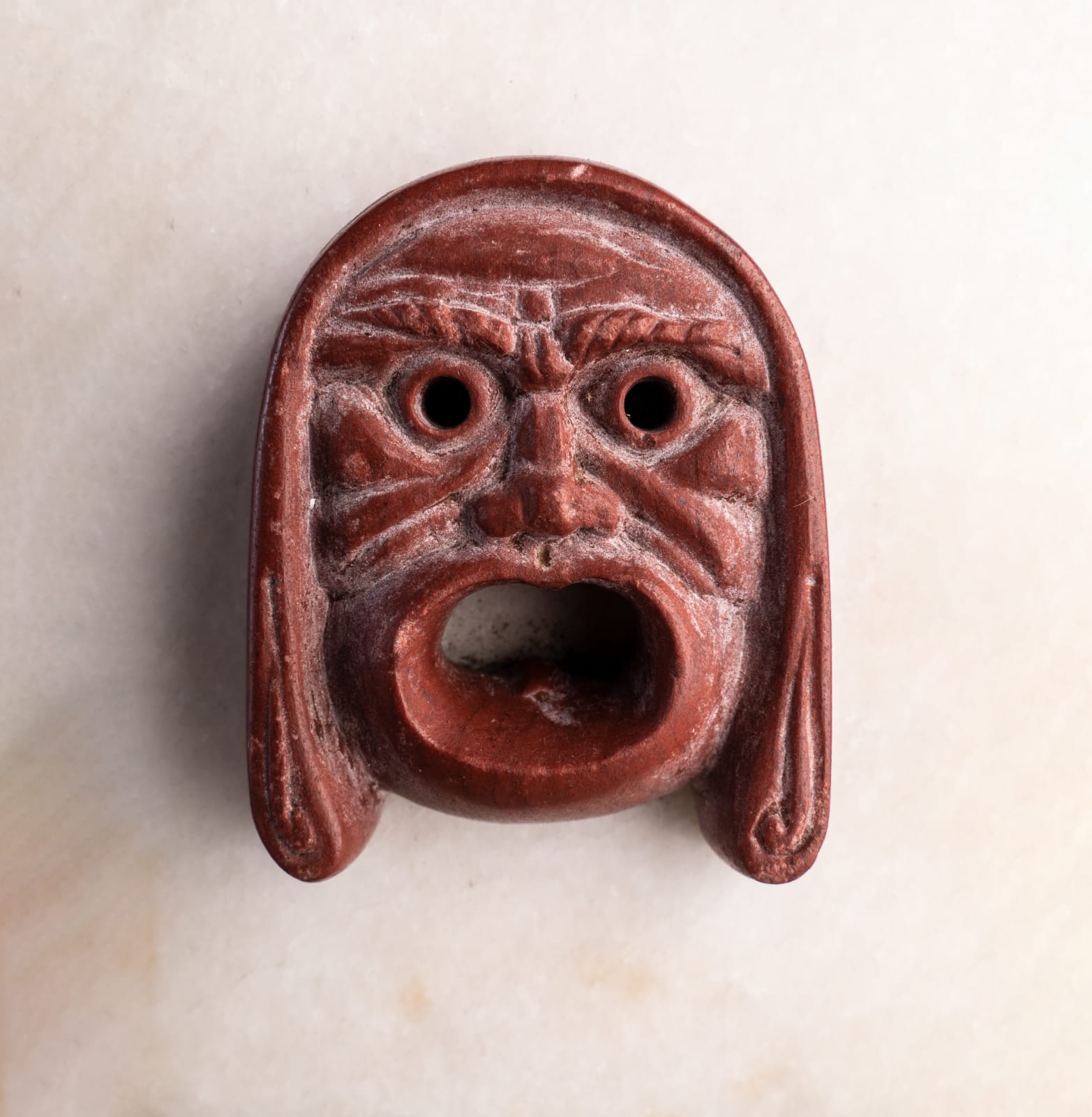 ROSSO ANTICO THEATRICAL MASK, Roman Empire, 1st Century A.D.