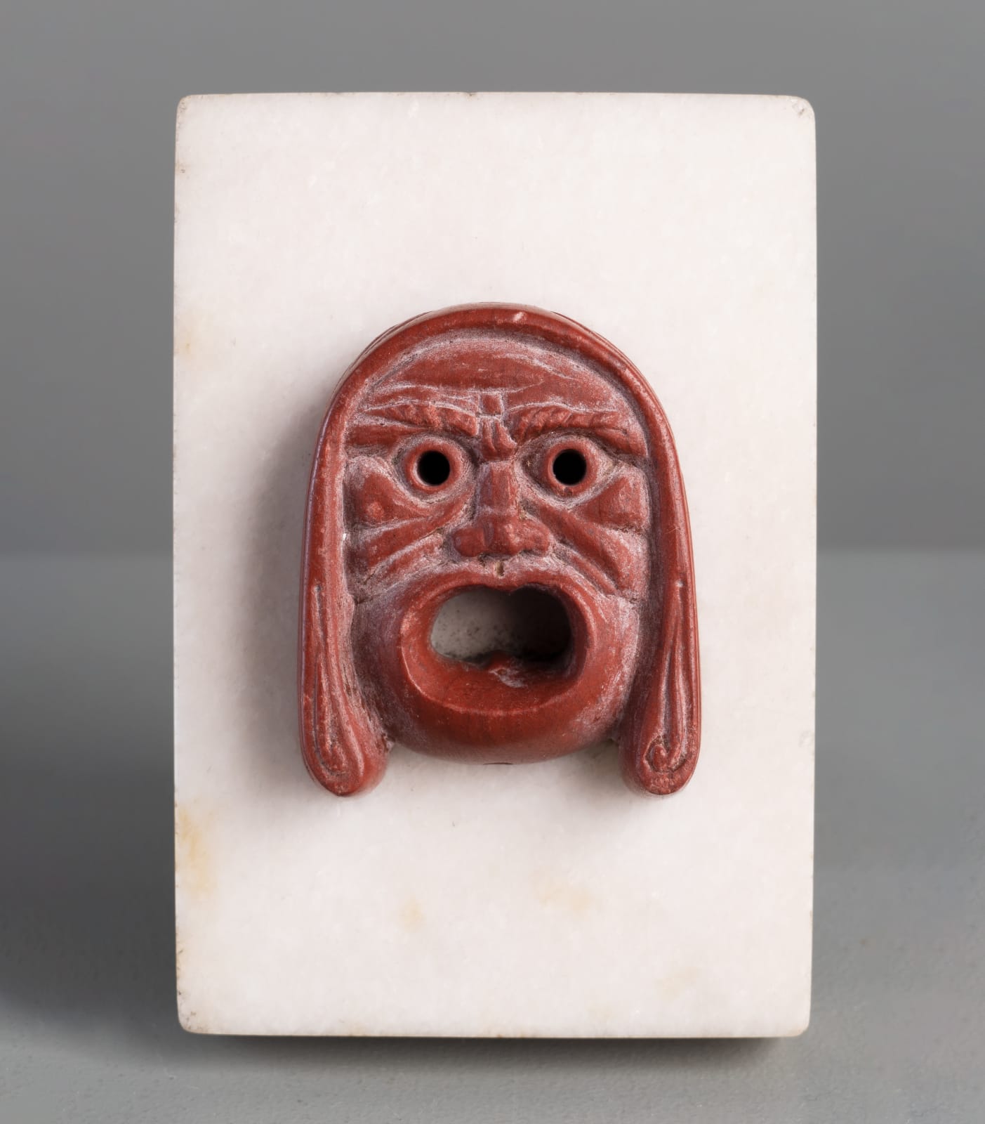 ROSSO ANTICO THEATRICAL MASK, Roman Empire, 1st Century A.D.