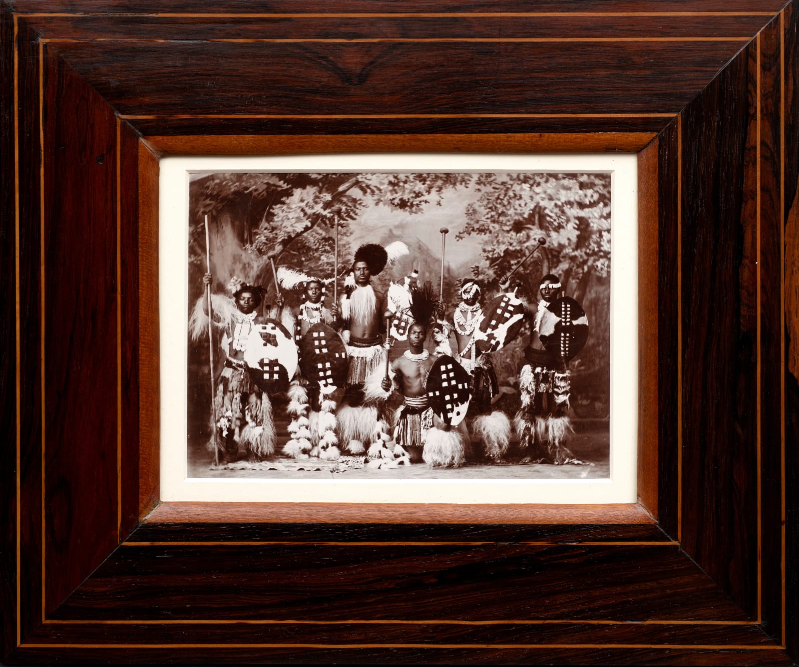 ARMSTRONG PHOTOGRAPHIC STUDIO, Seven Zulu warriors with cowhide shields, staffs and knobkerries