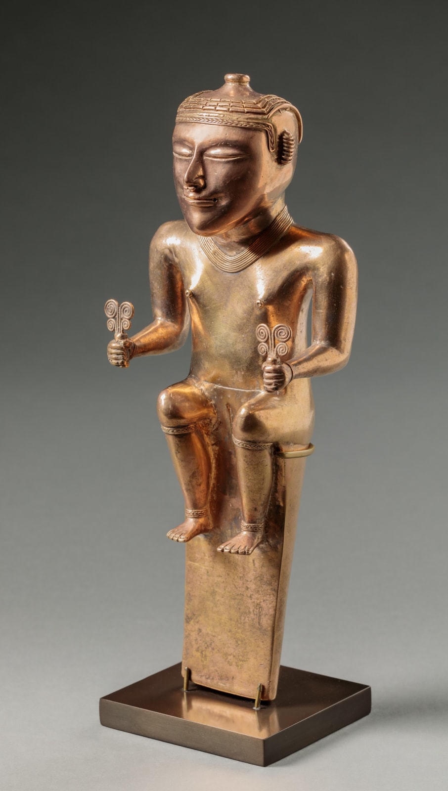 QUIMBAYA ARTIST, Poporo of a Seated Female Holding Ceremonial Objects with Scrolls, Middle Cauca valley, Colombia, 400-1000 AD