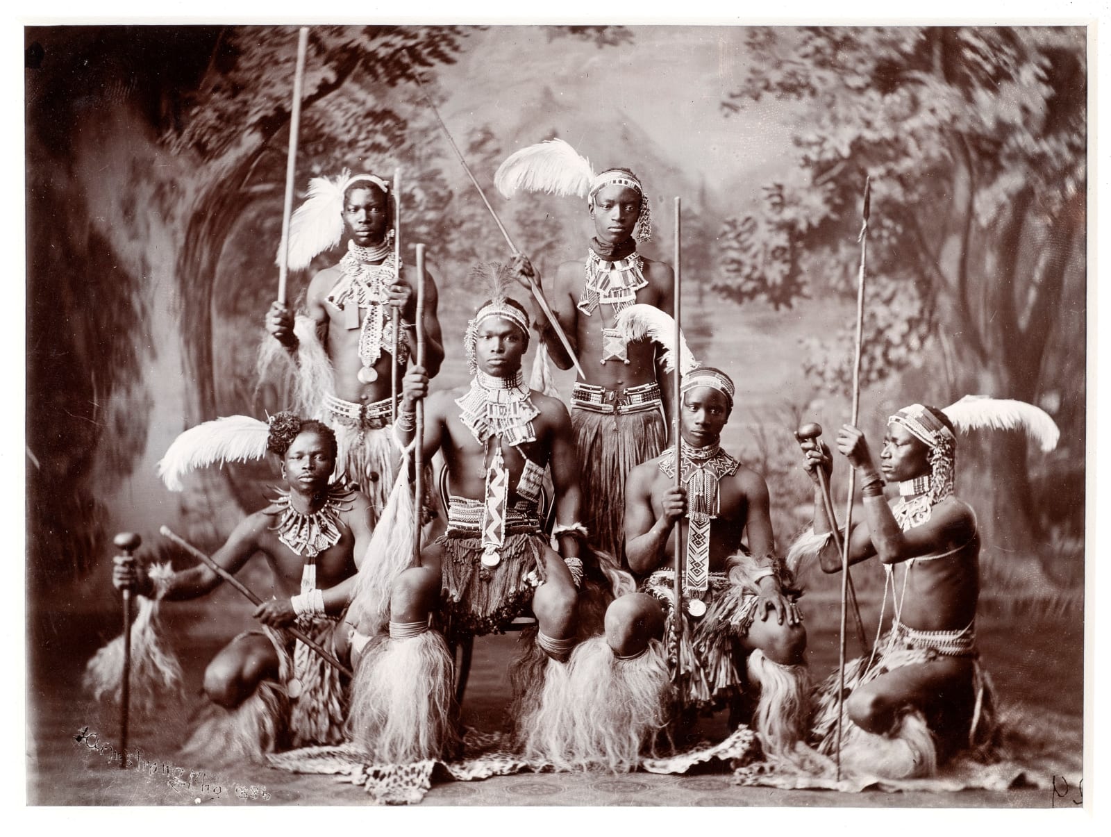 ARMSTRONG PHOTOGRAPHIC STUDIO, Six Zulu warriors with spears, staffs and knobkerries
