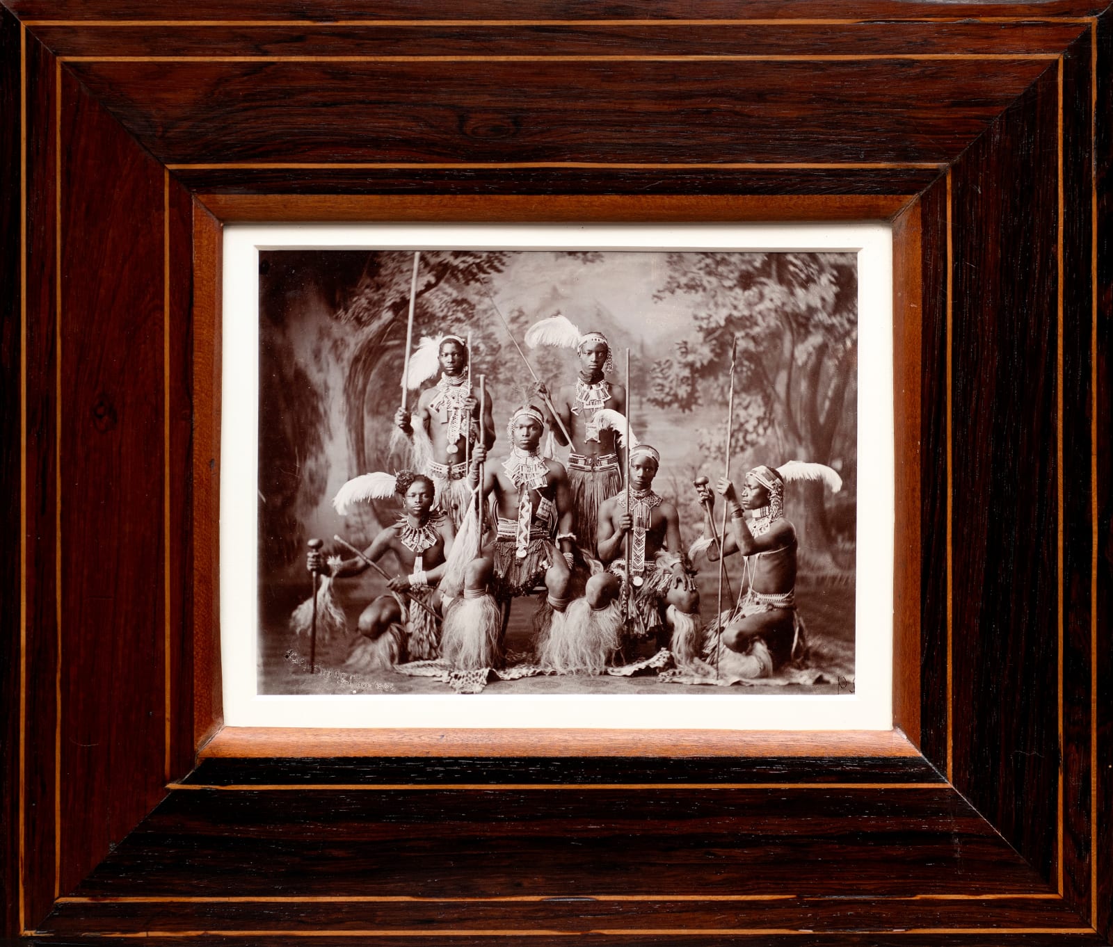 ARMSTRONG PHOTOGRAPHIC STUDIO, Six Zulu warriors with spears, staffs and knobkerries