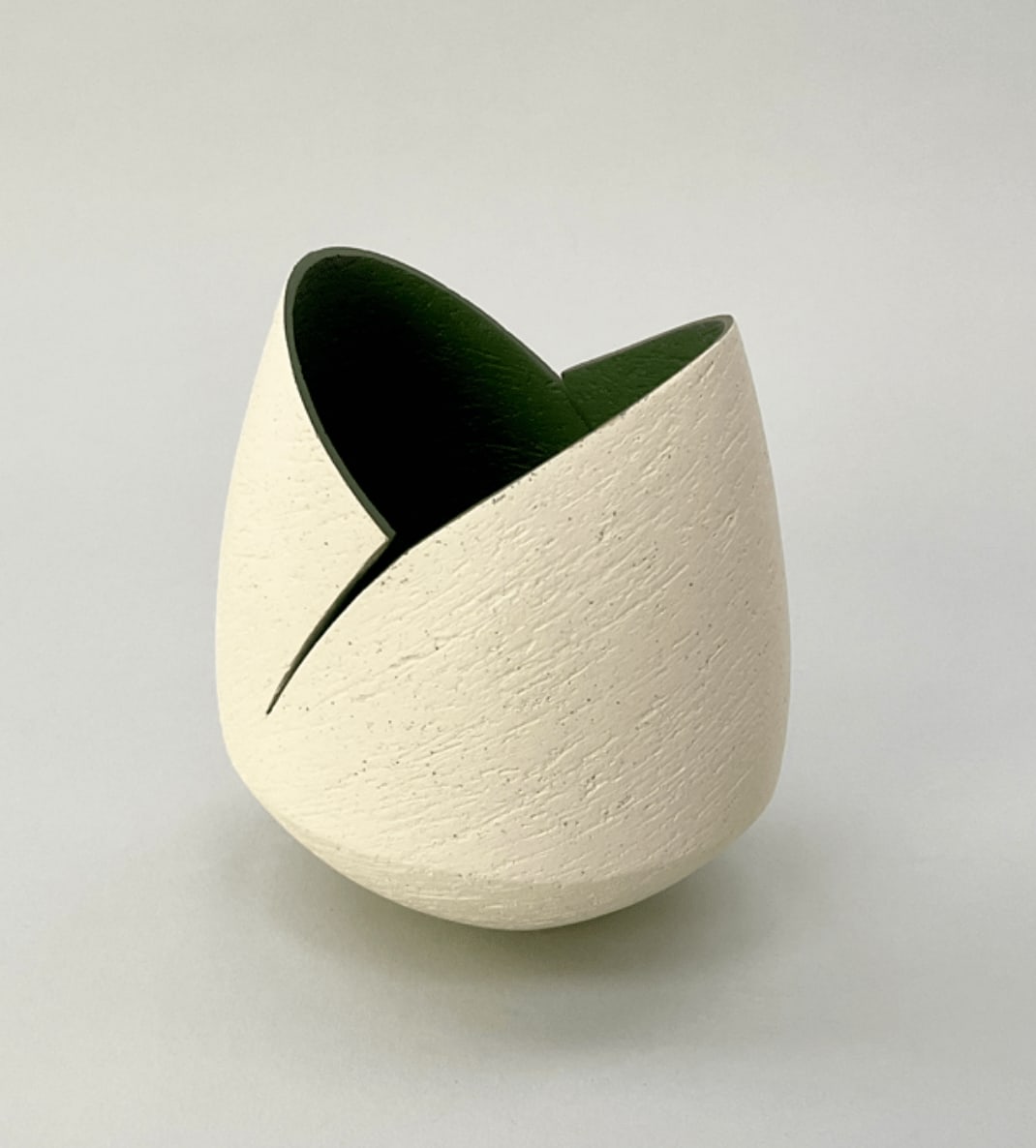 Ashraf Hanna, Ivory cut and altered pinch pot with dark sage interior