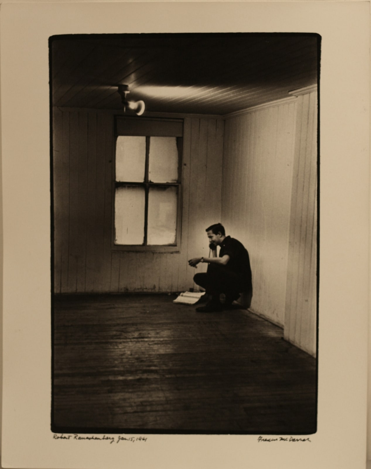 McDarrah, Rauschenberg on phone in Front St. loft, Jan. 15, 1961