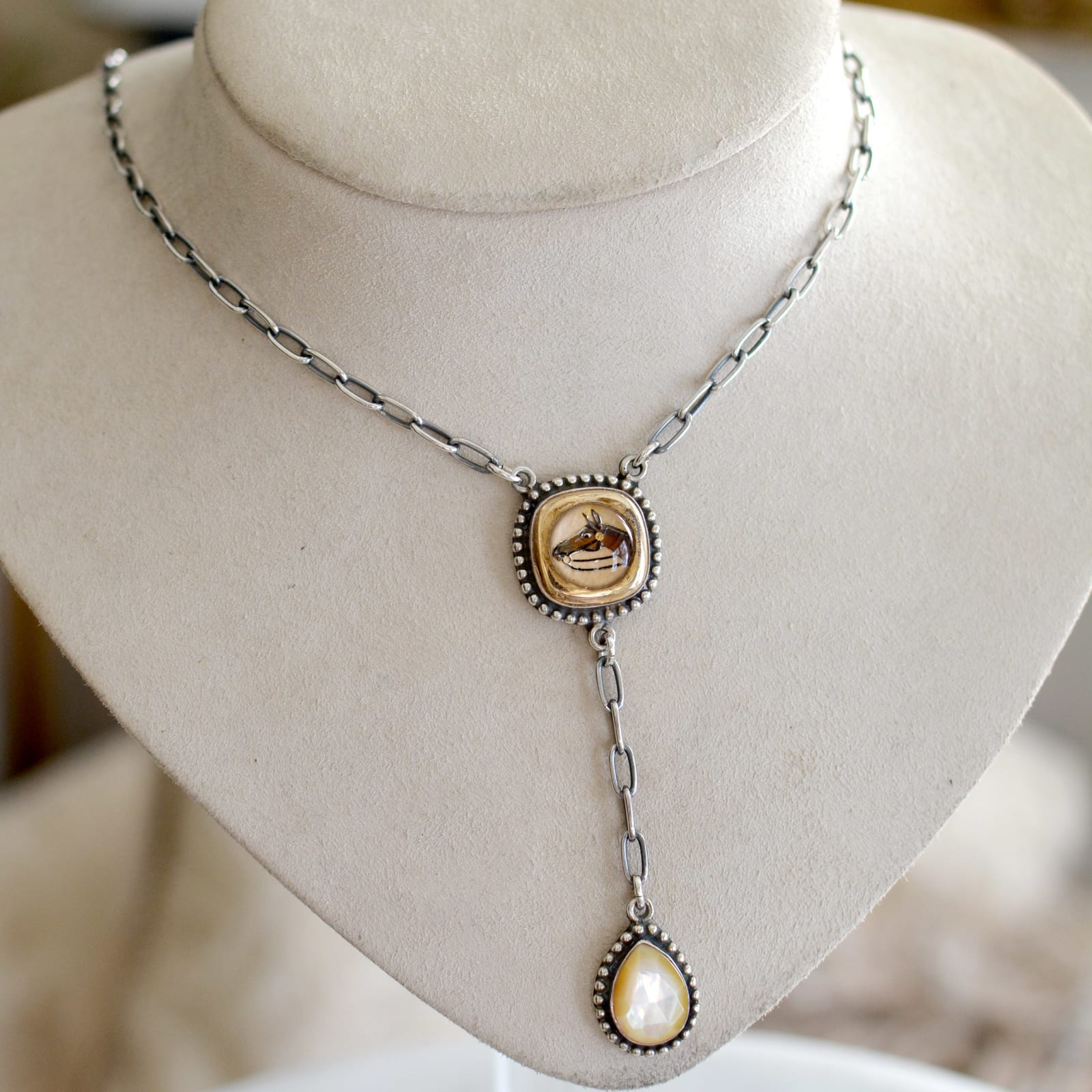 Jill Garber, A lovely lingerie necklace comprised of an original early 20th Century English intaglio depicting a horses head rendered in shades of brown, and black, reverse painted within crystal